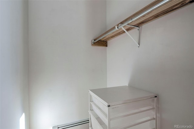 spacious closet featuring a baseboard heating unit