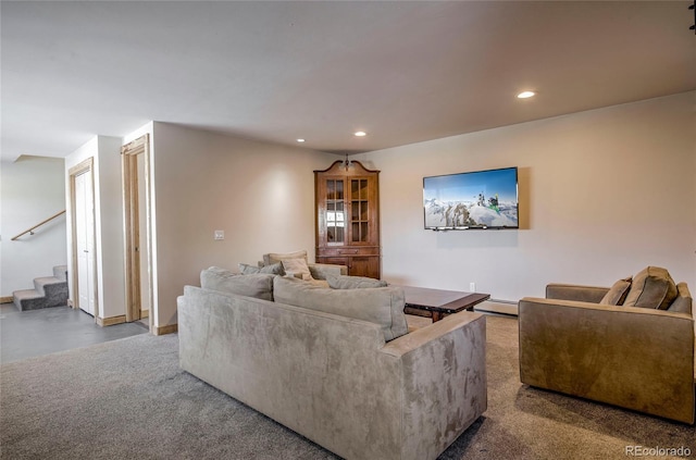 living room with a baseboard radiator, stairs, and recessed lighting