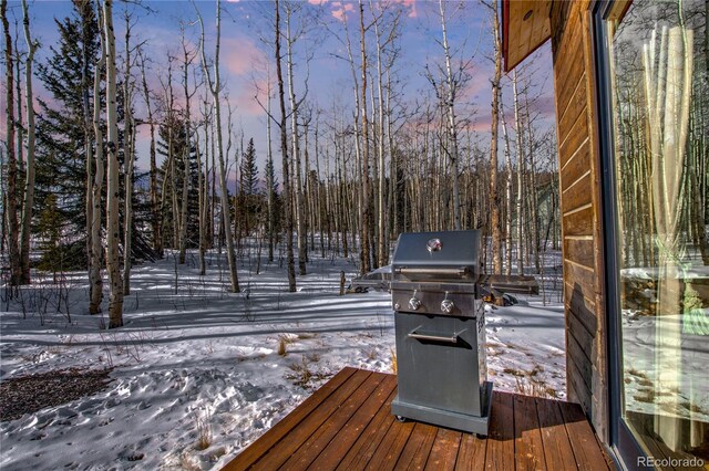 snow covered deck featuring grilling area