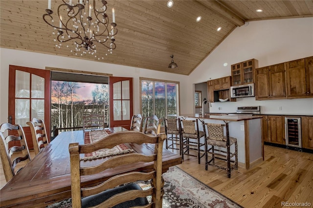 dining room with beverage cooler, beam ceiling, wooden ceiling, and light wood-style flooring