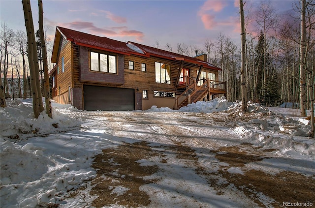 chalet / cabin featuring an attached garage