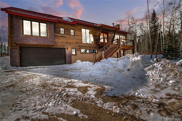 view of front of property featuring stairs and a garage