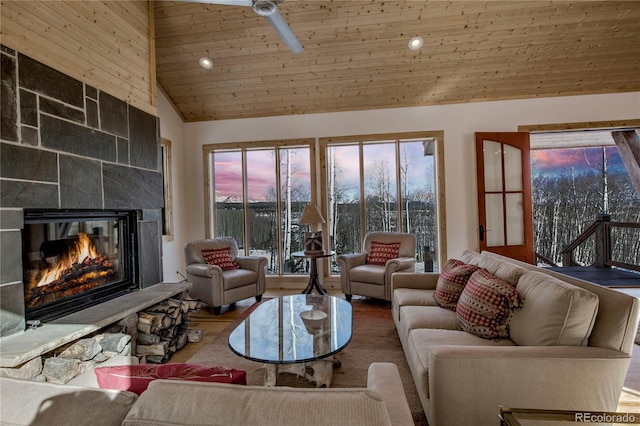 living room with a glass covered fireplace, wooden ceiling, wood finished floors, high vaulted ceiling, and recessed lighting