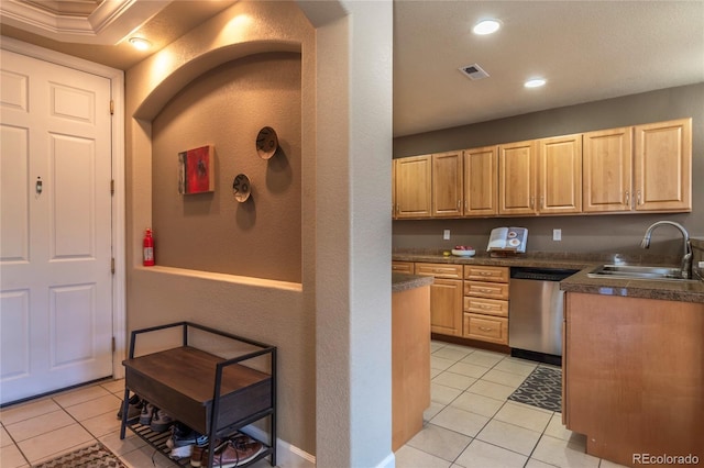 kitchen featuring a sink, visible vents, stainless steel dishwasher, and light brown cabinets