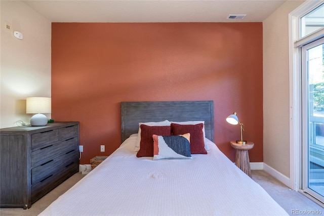 bedroom featuring visible vents, light colored carpet, baseboards, and access to outside