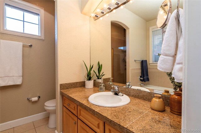 full bathroom with tile patterned flooring, baseboards, toilet, a shower with shower door, and vanity