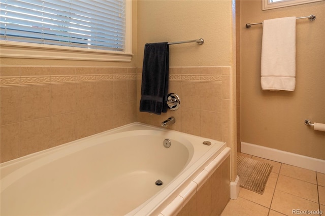 full bathroom featuring tile patterned flooring, a garden tub, and baseboards