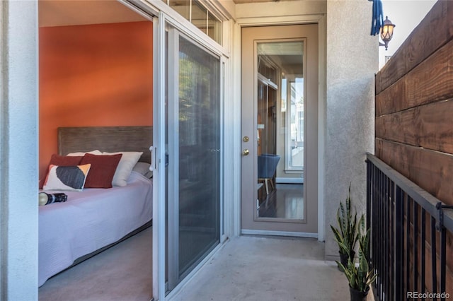 doorway to property featuring stucco siding