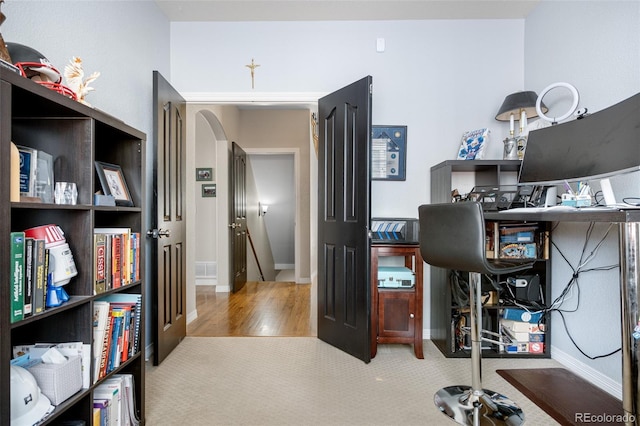 carpeted office featuring baseboards