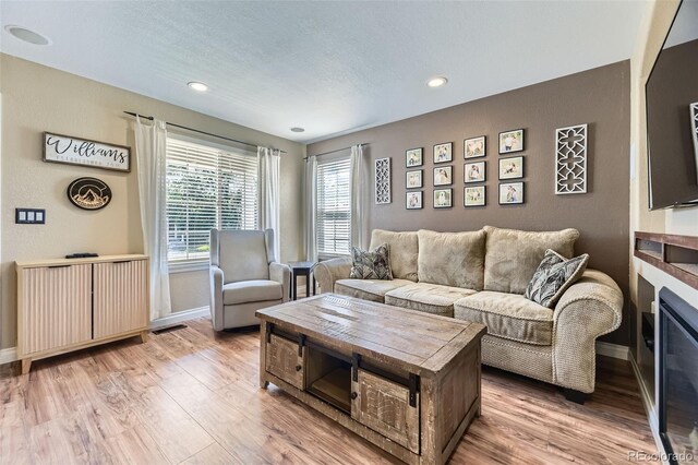 5090 Miriam Ln, Parker, CO 80134 - living room with wood finished floors, recessed lighting, and a glass covered fireplace