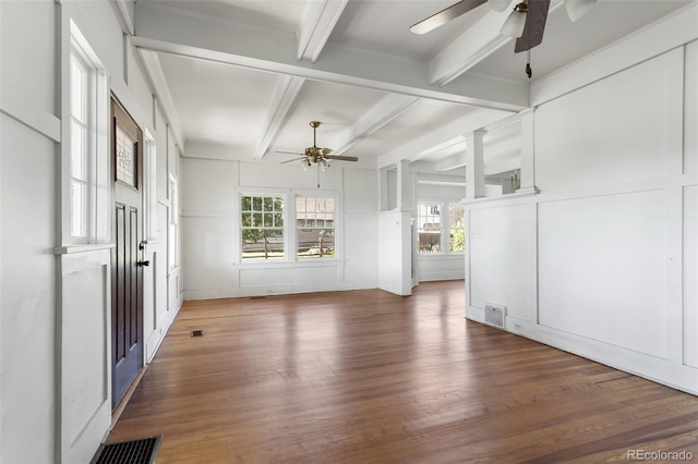 7801 Valley View St, Louviers, CO 80131 - unfurnished room featuring ceiling fan, wood finished floors, a decorative wall, and beamed ceiling