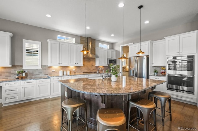 7797 S Valleyhead Way, Aurora, CO 80016 - kitchen featuring a sink, appliances with stainless steel finishes, wall chimney exhaust hood, and dark wood-type flooring