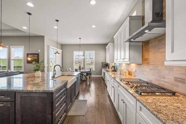 7797 S Valleyhead Way, Aurora, CO 80016 - kitchen featuring dark wood finished floors, wall chimney range hood, white cabinetry, and a sink