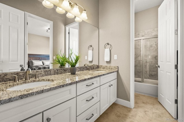 7797 S Valleyhead Way, Aurora, CO 80016 - full bath with baseboards, ensuite bathroom, double vanity, and a sink
