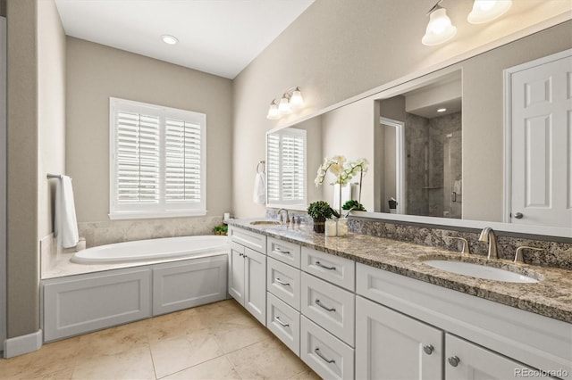 7797 S Valleyhead Way, Aurora, CO 80016 - full bathroom with double vanity, a garden tub, a stall shower, and a sink