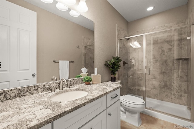 7797 S Valleyhead Way, Aurora, CO 80016 - full bathroom with a stall shower, recessed lighting, toilet, tile patterned flooring, and vanity