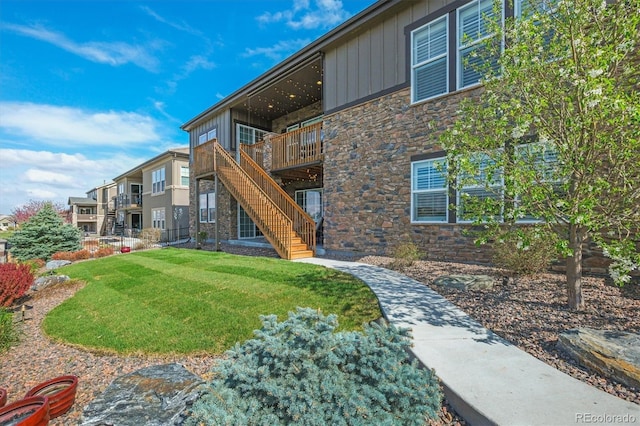 7797 S Valleyhead Way, Aurora, CO 80016 - view of property's community with a yard, stairs, and a wooden deck