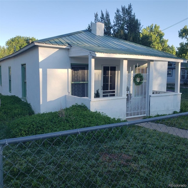 511 N Petroleum Ave, Florence, CO 81226 - view of front of property featuring a standing seam roof, stucco siding, and metal roof