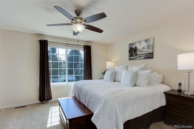 carpeted bedroom featuring visible vents, baseboards, and ceiling fan