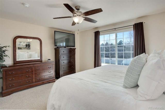 bedroom featuring access to exterior, a ceiling fan, and carpet floors