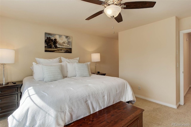bedroom featuring baseboards, ceiling fan, and light carpet