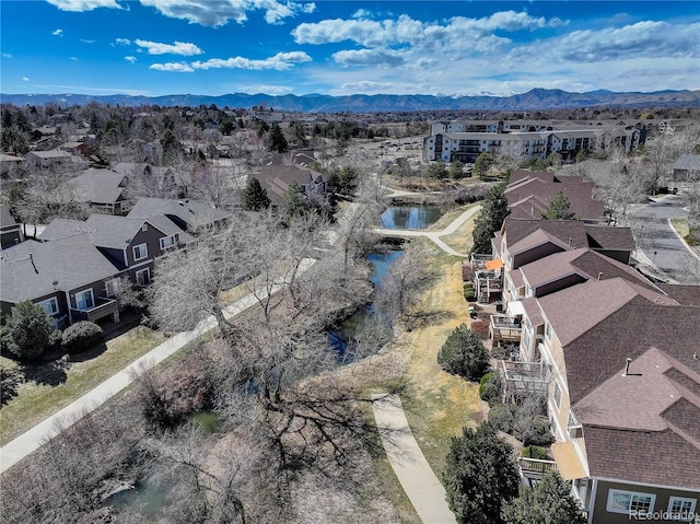 drone / aerial view with a water and mountain view and a residential view