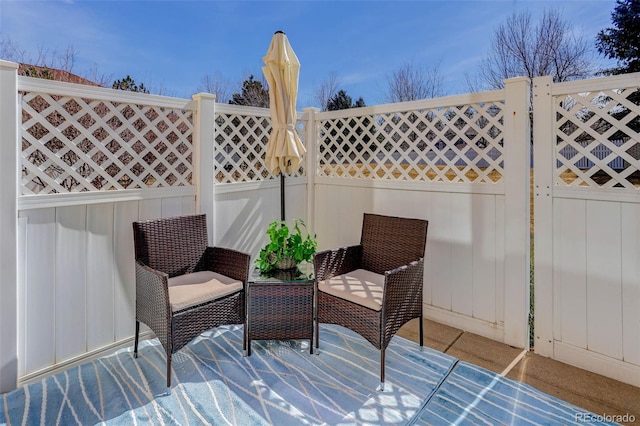 view of patio featuring fence