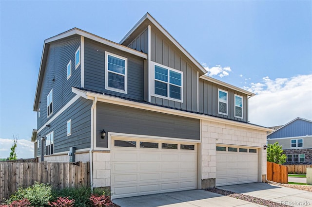 21821 E 7th Ave, Aurora, CO 80018 - view of front facade featuring a garage, board and batten siding, and driveway