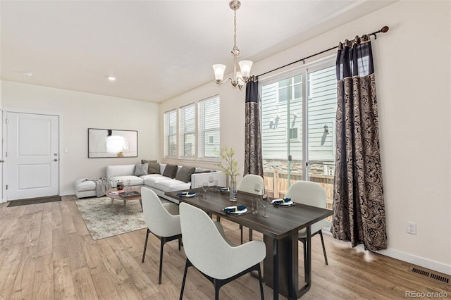 21821 E 7th Ave, Aurora, CO 80018 - dining area featuring light wood-style flooring and a chandelier
