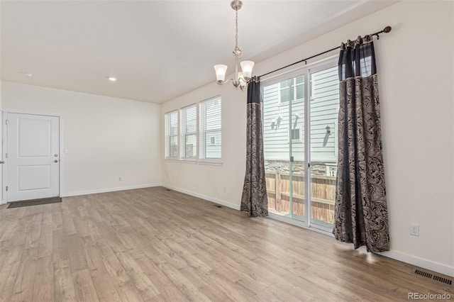 21821 E 7th Ave, Aurora, CO 80018 - spare room featuring light wood-style floors, a chandelier, and recessed lighting