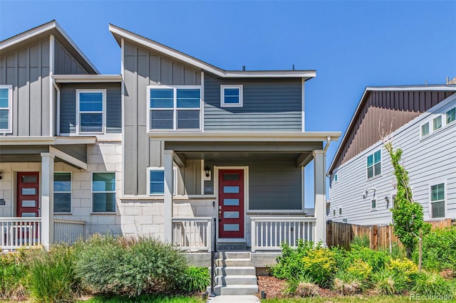 21821 E 7th Ave, Aurora, CO 80018 - view of front of home with a porch and board and batten siding