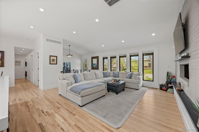 living room with visible vents, recessed lighting, and light wood-style floors