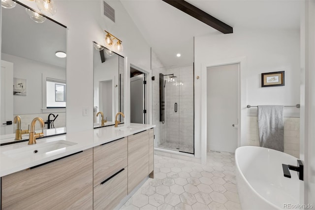 full bathroom featuring visible vents, double vanity, a freestanding tub, a shower stall, and a sink