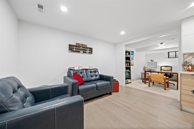 living room featuring light wood-style floors, recessed lighting, and visible vents