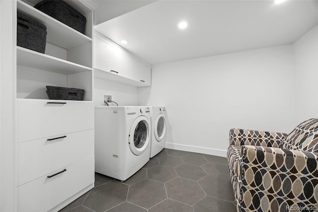 laundry room featuring washing machine and clothes dryer, cabinet space, recessed lighting, baseboards, and dark tile patterned floors