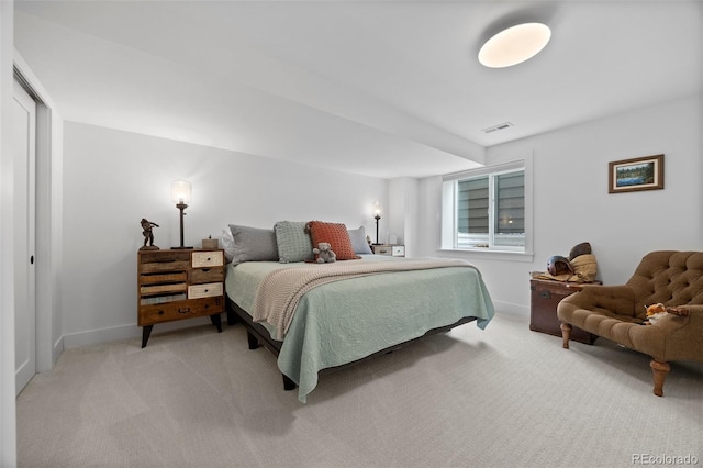 bedroom featuring baseboards, visible vents, and light carpet