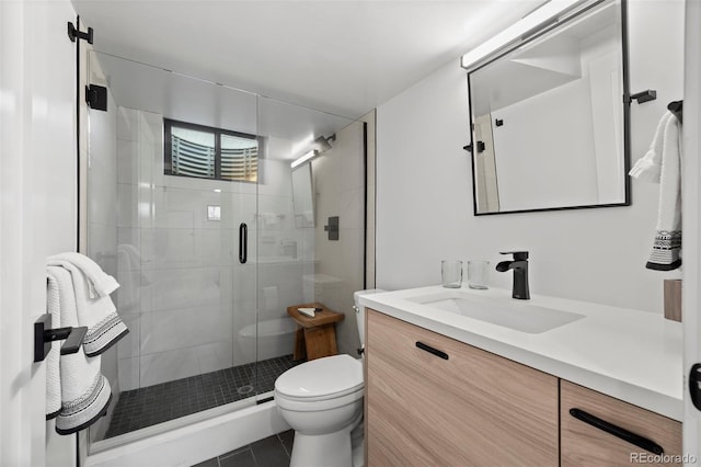 full bathroom featuring toilet, a shower stall, tile patterned flooring, and vanity