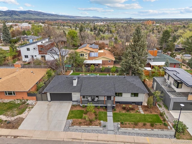 birds eye view of property with a mountain view and a residential view