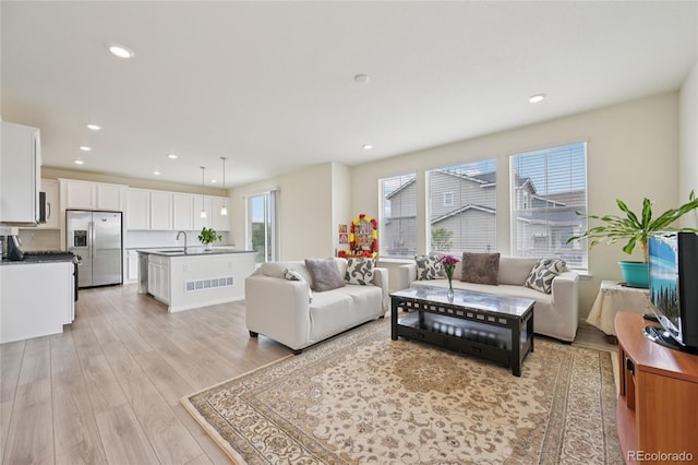 12854 Clearview St, Firestone, CO 80504 - living area featuring light wood-type flooring and recessed lighting