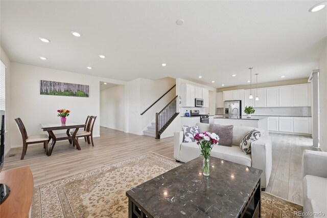 12854 Clearview St, Firestone, CO 80504 - living room featuring stairs, light wood-type flooring, and recessed lighting