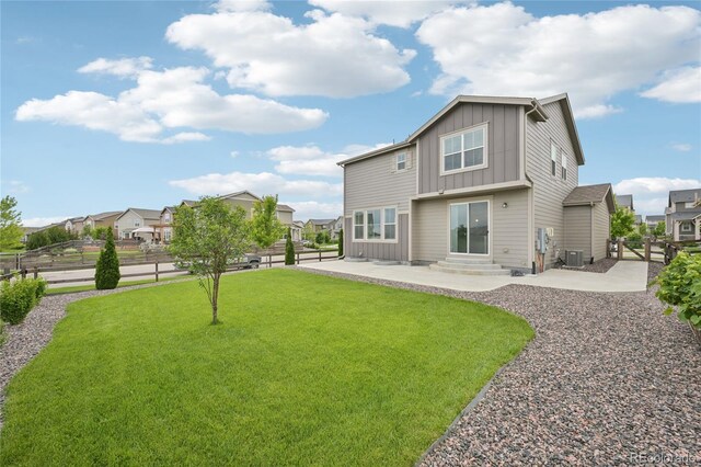 12854 Clearview St, Firestone, CO 80504 - rear view of property featuring board and batten siding, a patio area, a fenced backyard, entry steps, and a residential view