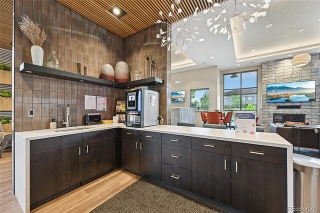 12854 Clearview St, Firestone, CO 80504 - kitchen with a peninsula, light countertops, open shelves, light wood finished floors, and open floor plan