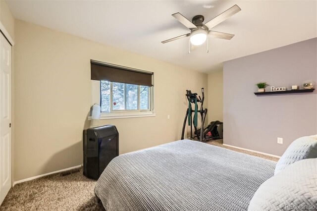 bedroom with ceiling fan, carpet, and a closet