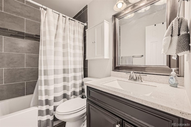 full bathroom with vanity, shower / tub combo, and toilet