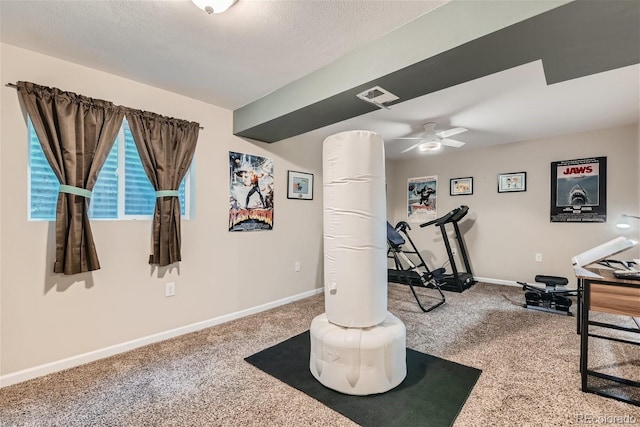 workout area featuring carpet flooring and ceiling fan