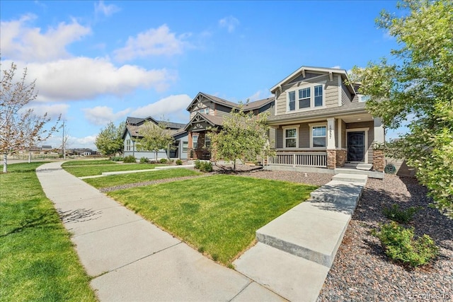craftsman-style house featuring covered porch and a front yard