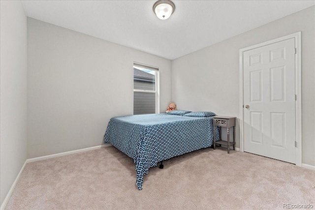 bedroom with baseboards and carpet
