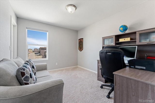 carpeted office space featuring baseboards