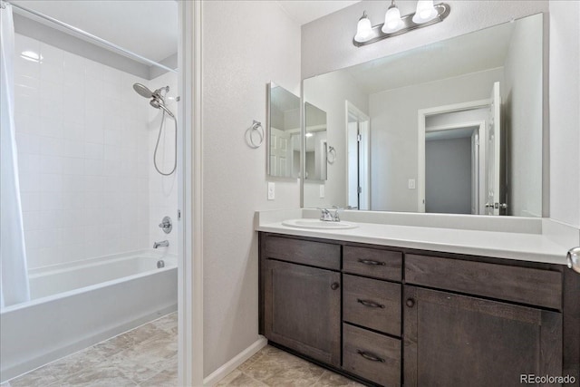 full bath with vanity, baseboards, and bathing tub / shower combination
