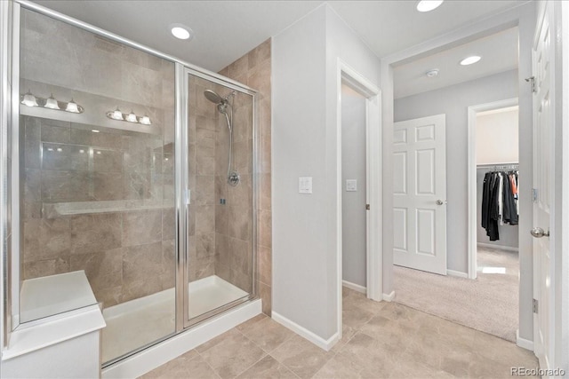 bathroom featuring baseboards, tile patterned flooring, a shower stall, and recessed lighting